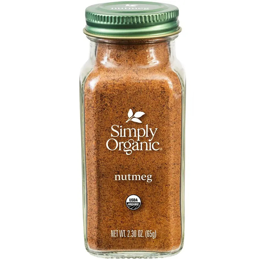 A glass jar of Simply Organic nutmeg spice blend with a green metal lid, shown on a plain white background.