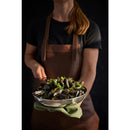 Person holding a pry pan of mussels with a dark background