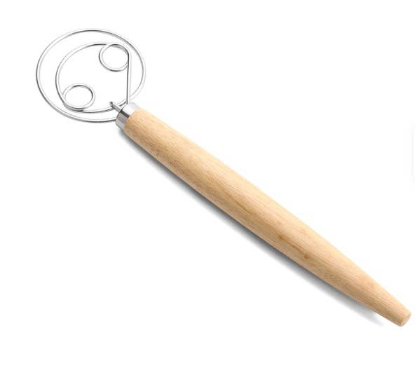 Metallic dough whisk with wooden handle on a white background