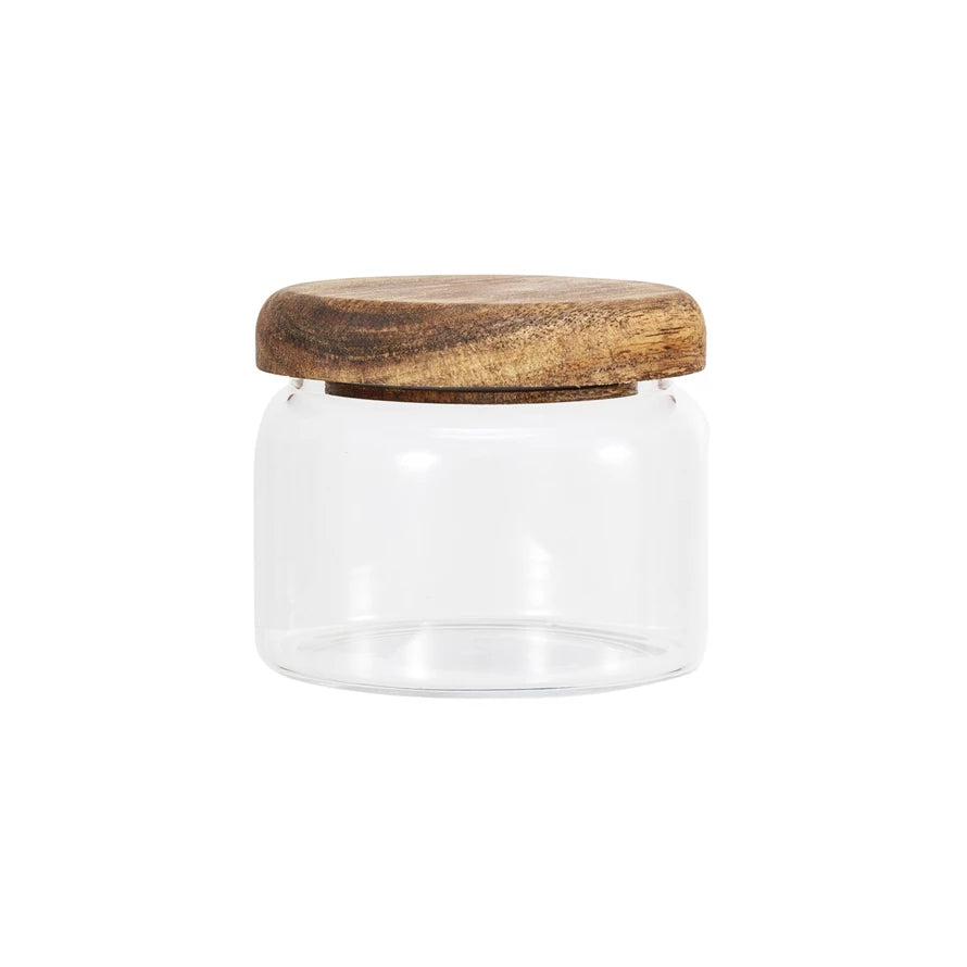 A clear glass canister with an acacia wood lid, suitable for food storage.