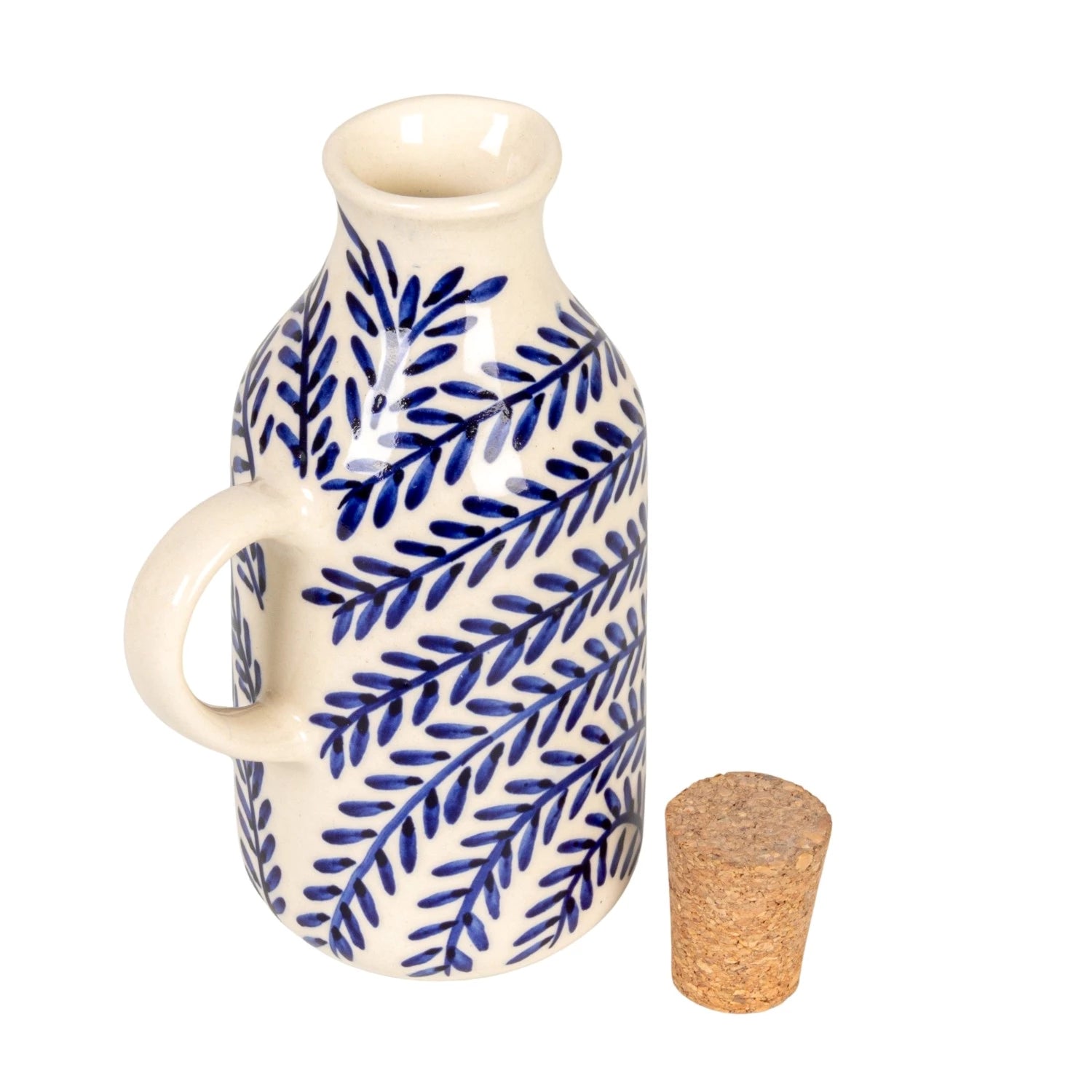 Ceramic oil bottle with blue leaf pattern and cork stopper on a white background