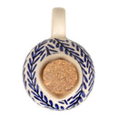 Ceramic cruet with blue leaf pattern and cork base on a white background