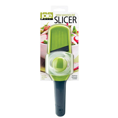 Green Joie mini mandoline slicer with packaging on a white background
