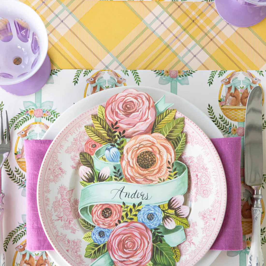Decorative place setting with floral design and name tag.