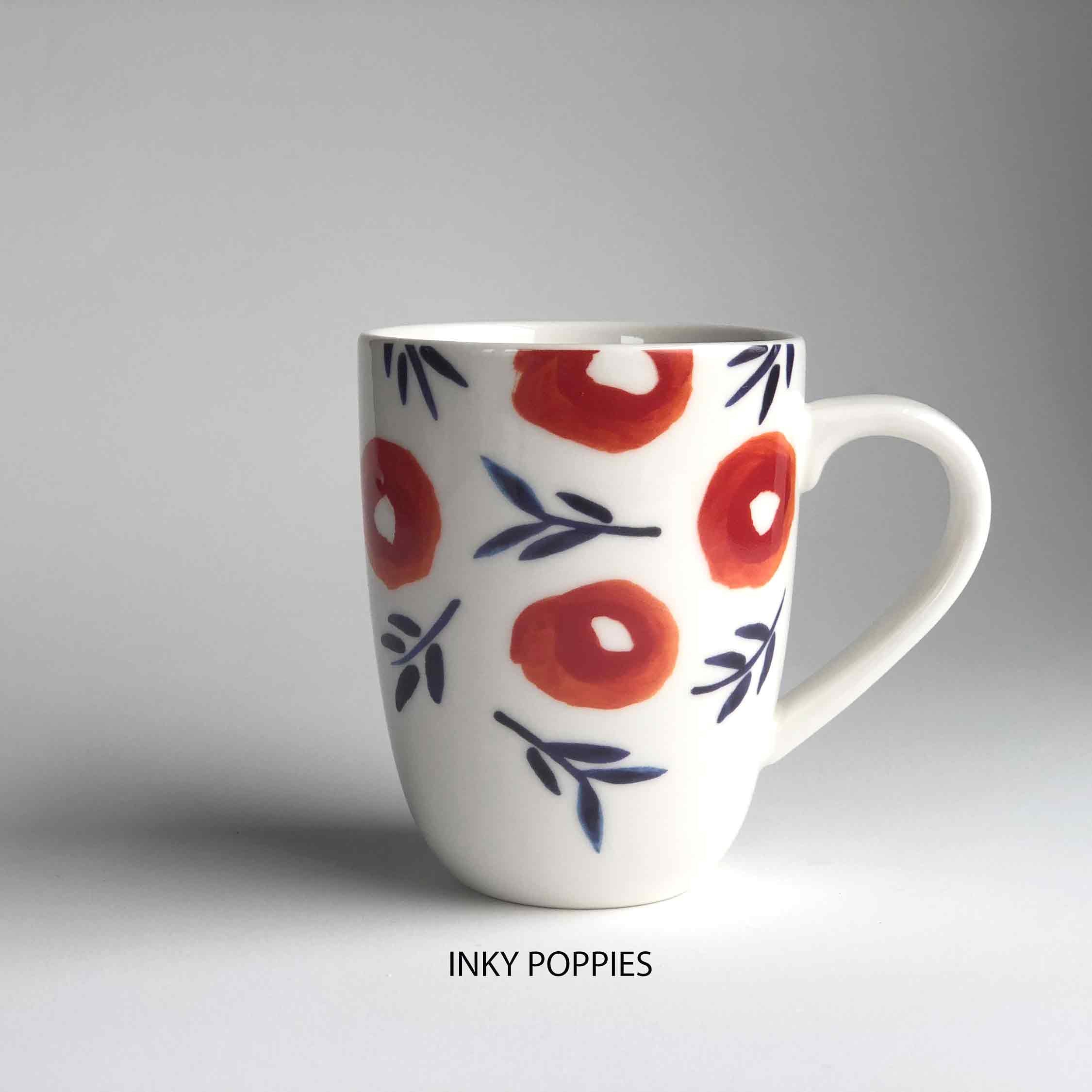 A ceramic mug with floral pattern and 'inky poppies' description underneath.