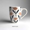 A ceramic mug with floral pattern and 'peach tulips' description underneath.
