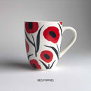 A ceramic mug with red poppy floral pattern and 'red poppies' description underneath.