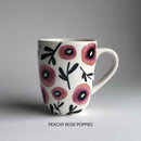 A ceramic mug with pink floral pattern and 'peachy rose poppies' description underneath.