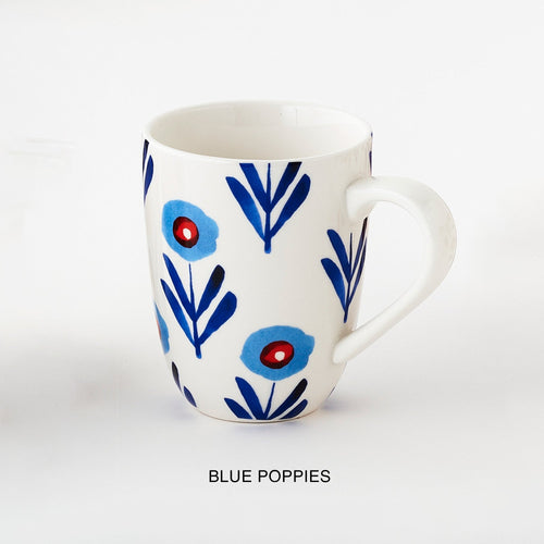 A ceramic mug with blue floral pattern and 'blue poppies' description underneath.