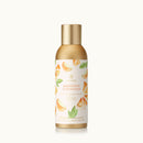 Bottle of Mandarin Coriander body spray with a gold cap on a white background.