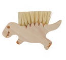 Wooden dino-shaped brush with bristles on a white background