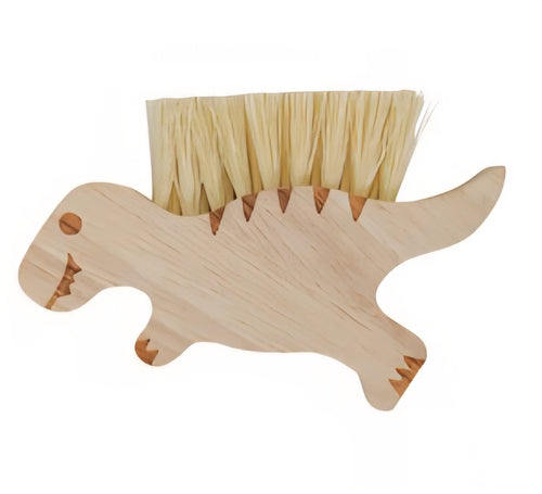 Wooden dino-shaped brush with bristles on a white background