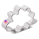 Metallic stegosaurus cookie cutter with 'Made in USA' label on a white background