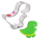 Dinosaur-shaped cookie cutter with a green dinosaur cookie example on a white background