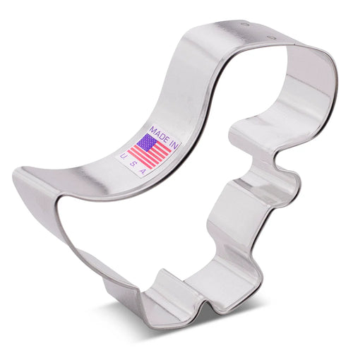 Metallic dinosaur cookie cutter with 'Made in USA' label on a white background