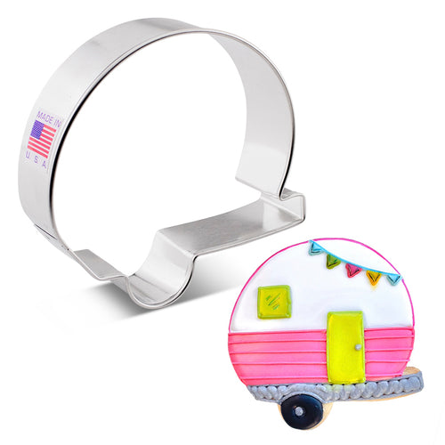 A metal camper-shaped cookie cutter with a decorative illustration of a pink and white camper cookie on a white background.