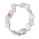 Metallic wreath-shaped cookie cutter with 'Made in USA' label on a white background