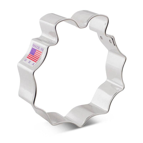 Metallic wreath-shaped cookie cutter with 'Made in USA' label on a white background
