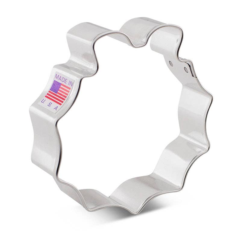 Metallic wreath-shaped cookie cutter with 'Made in USA' label on a white background