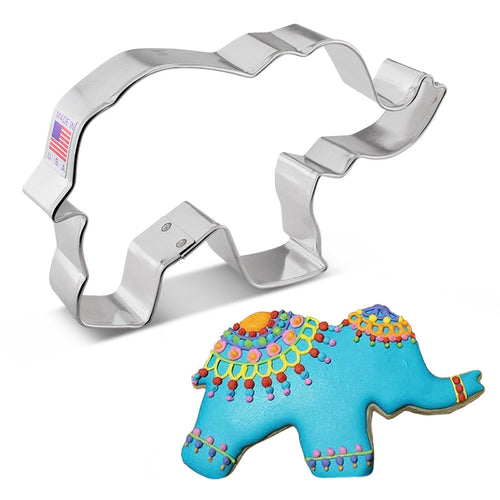 A stainless steel elephant-shaped cookie cutter. Below it, there is a decorated cookie shaped like an elephant.