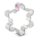 Metallic snowflake cookie cutter with 'Made in USA' label on a white background