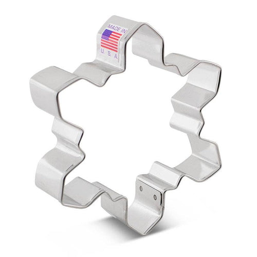Metallic snowflake cookie cutter with 'Made in USA' label on a white background