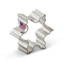 Metallic cookie cutter with American flag label indicating it is made in the USA on a white background