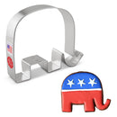 Metal cookie cutter shaped an elephant with a red, white, and blue elephant cookie on a white background