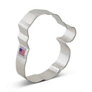 Metallic cookie cutter shaped like a Santa face on a white background