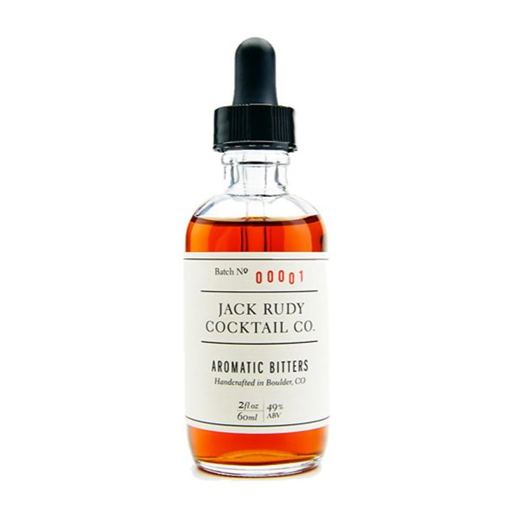 A bottle of Jack Rudy Aromatic Bitters with a dropper cap, labeled for use in cocktails.