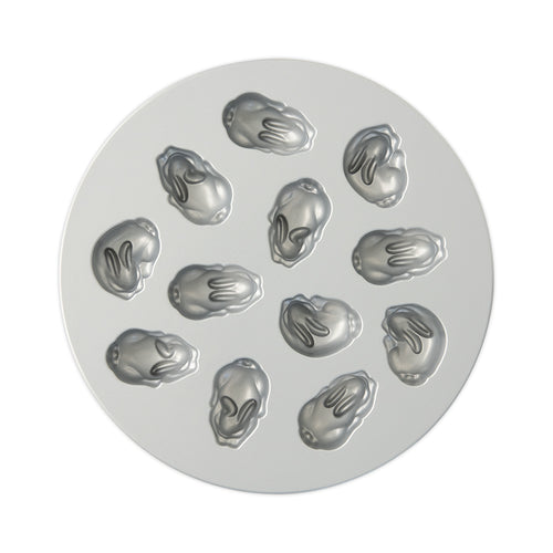 Circular metal mold with multiple baby bunny-shaped cavities on a white background