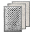 Three rectangular Oggi sponges stacked slightly offset, showing a silver-gray patterned front and soft off-white textured backs with gray edges, on a plain white background.