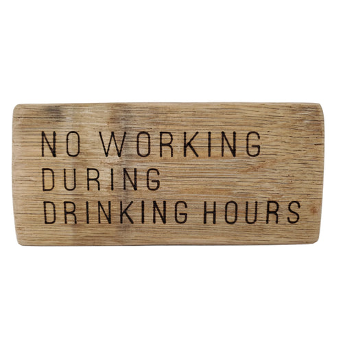 Wooden sign with text 'NO WORKING DURING DRINKING HOURS' on a white background