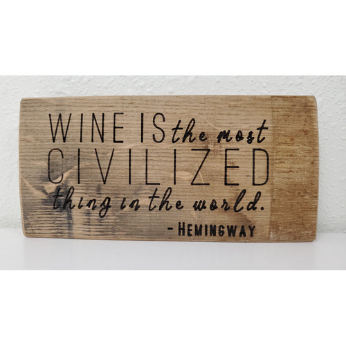 Wooden sign with Hemingway quote on a white background