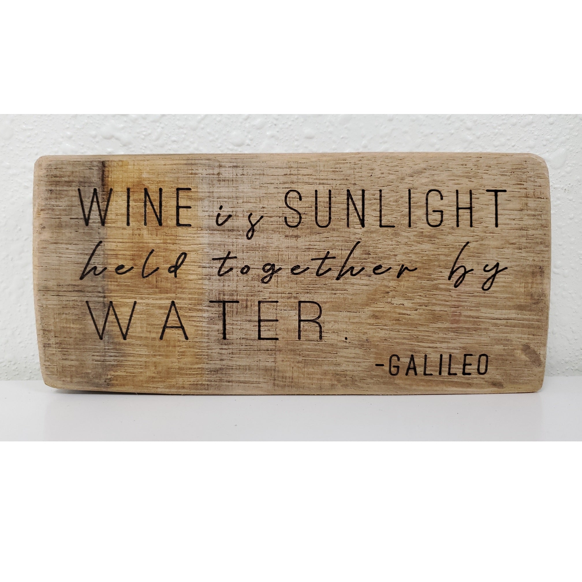 Wooden sign with engraved text on a white background