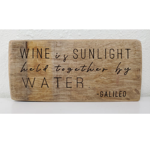 Wooden sign with engraved text on a white background
