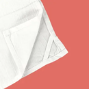 Close up look of towel loop on a kitchen towel on a red background.