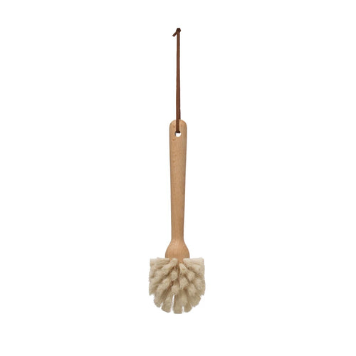 A beech wood dish brush with a leather strap, featuring white bristles and a long handle.