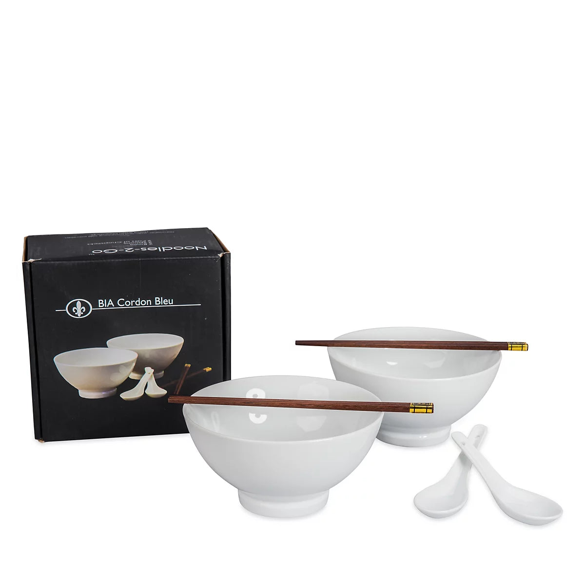 White ceramic bowl and spoon set with dark brown wooden chopsticks and gold-colored tips, shown with a black BIA Gordon Bleu branded box on a white background.