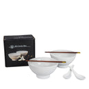 White ceramic bowl and spoon set with dark brown wooden chopsticks and gold-colored tips, shown with a black BIA Gordon Bleu branded box on a white background.