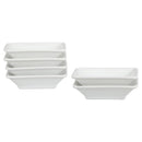 A set of white porcelain soy sauce dishes stacked together.