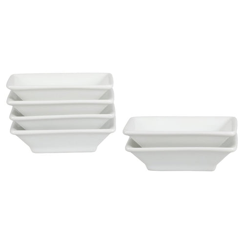 A set of white porcelain soy sauce dishes stacked together.