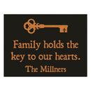 Decorative sign with a key symbol and text on a black background