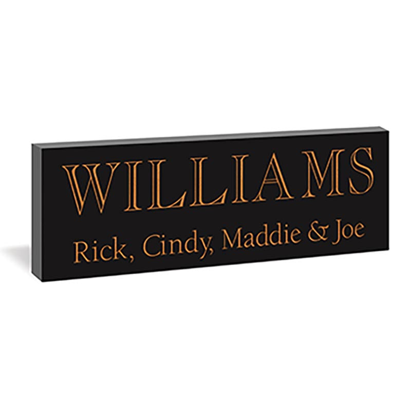 Black rectangular sign with engraved text displaying the name 'Williams' and family members' names.