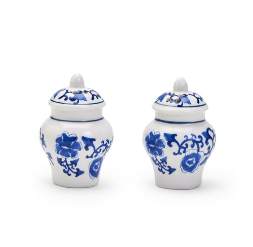 Two white ceramic salt and pepper shaker jars with blue floral patterns on a white background