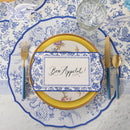 Elegant table setting with floral patterns and 'Bon Appetit' place card.