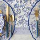 A close up of a place setting with blue and white table runner, knife, fork, and spoon.