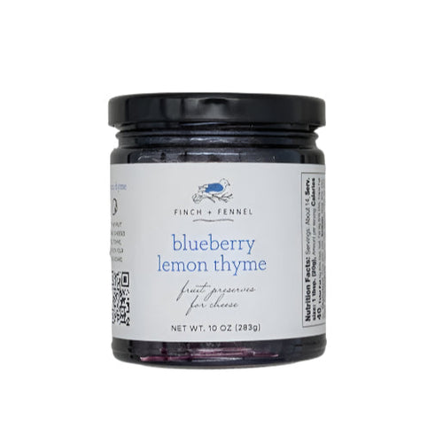 A jar of Blueberry Lemon Thyme jam on a white background.