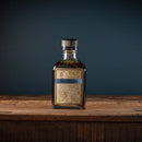 Bottle of soy sauce on a wooden surface with a dark background