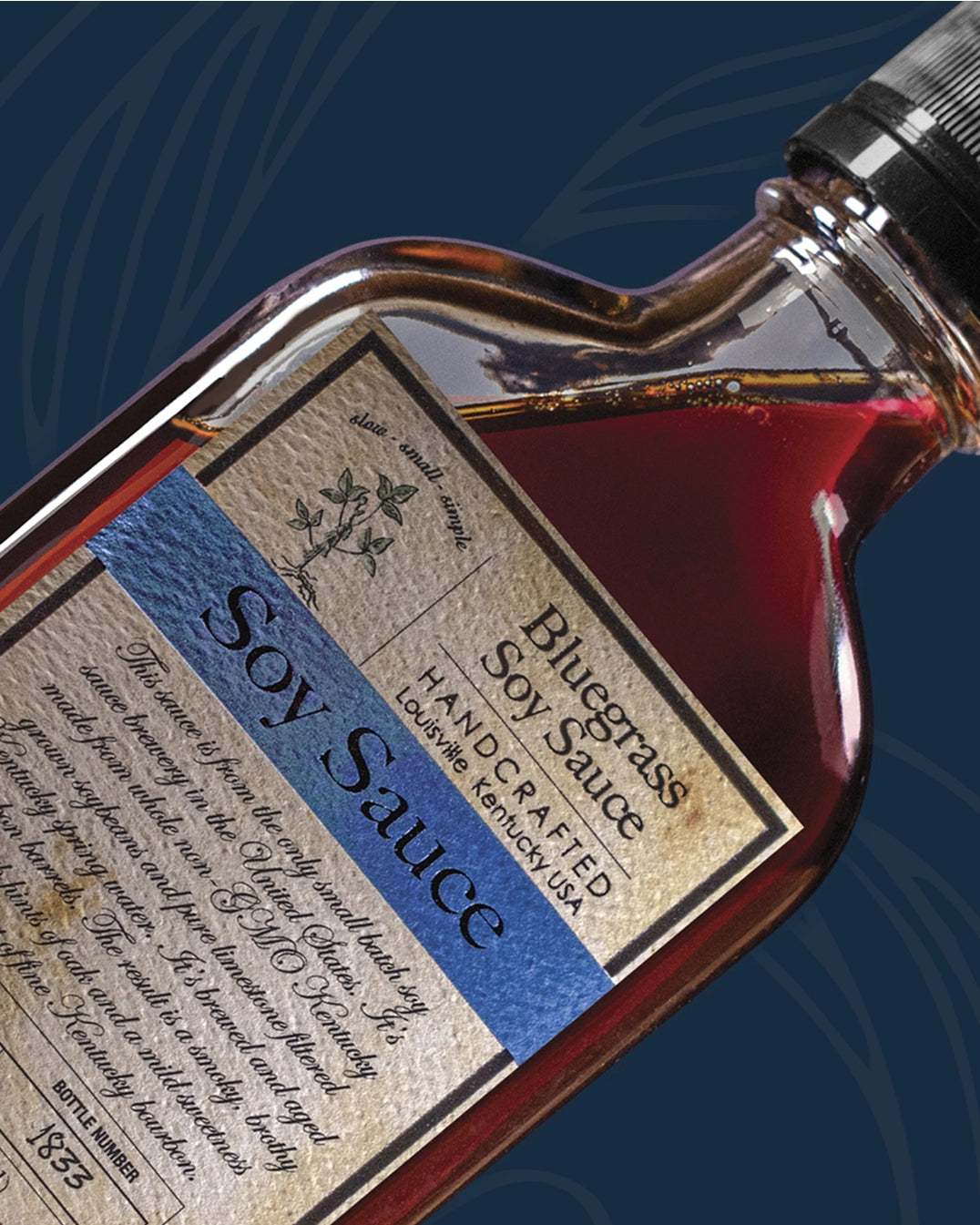 Bottle of Bluegrass Soy Sauce with a detailed label on a dark blue background